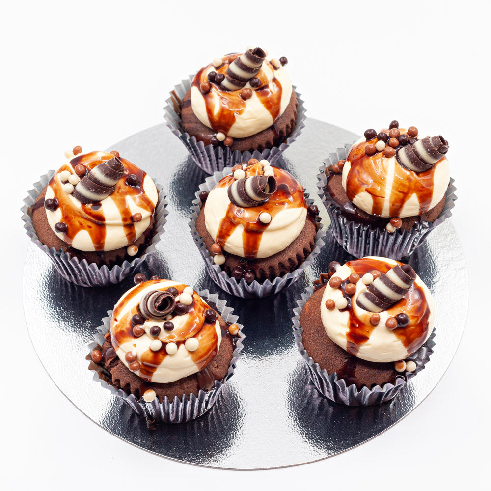 Six chocolate cupcakes, topped with butter cream and a chocolate swirl