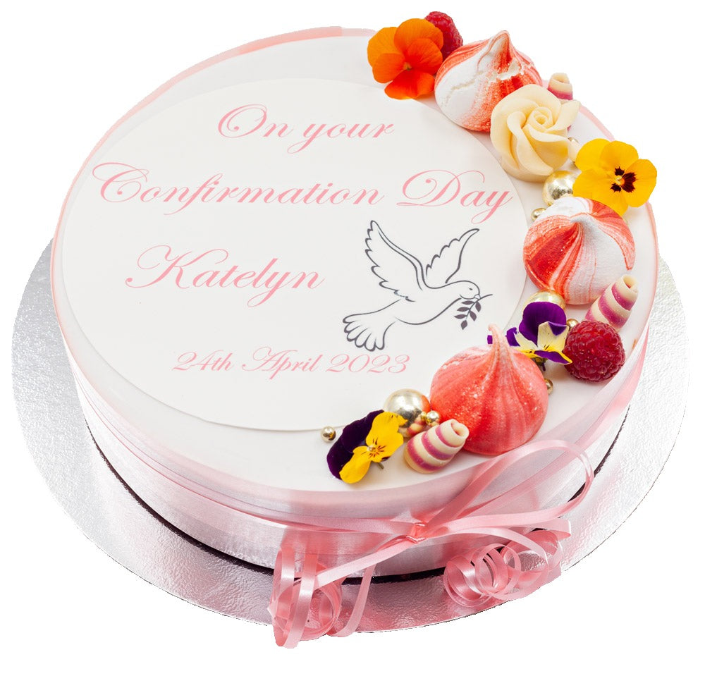 Confirmation cake decorated with meringue swirls, edible flowers and summer fruits.