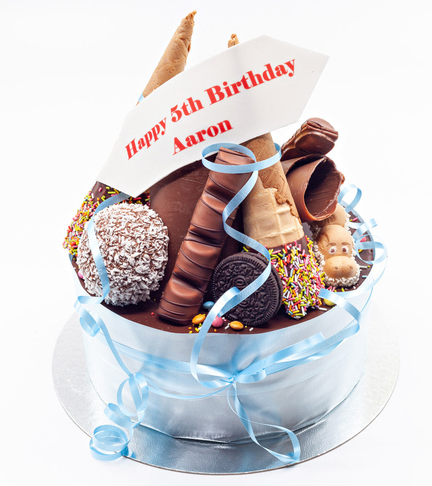 A birthday cake stacked with chocolate treats