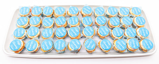 A platter holding 40 mini cupcakes with a birthday message on each one printed on to an edible disc